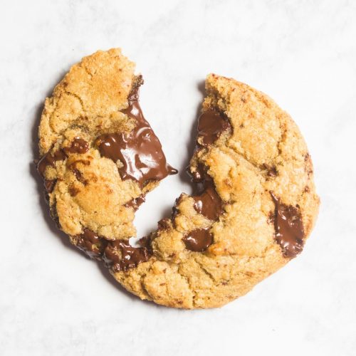 Single crispy on the outside, gooey on the inside chocolate chip cookie.