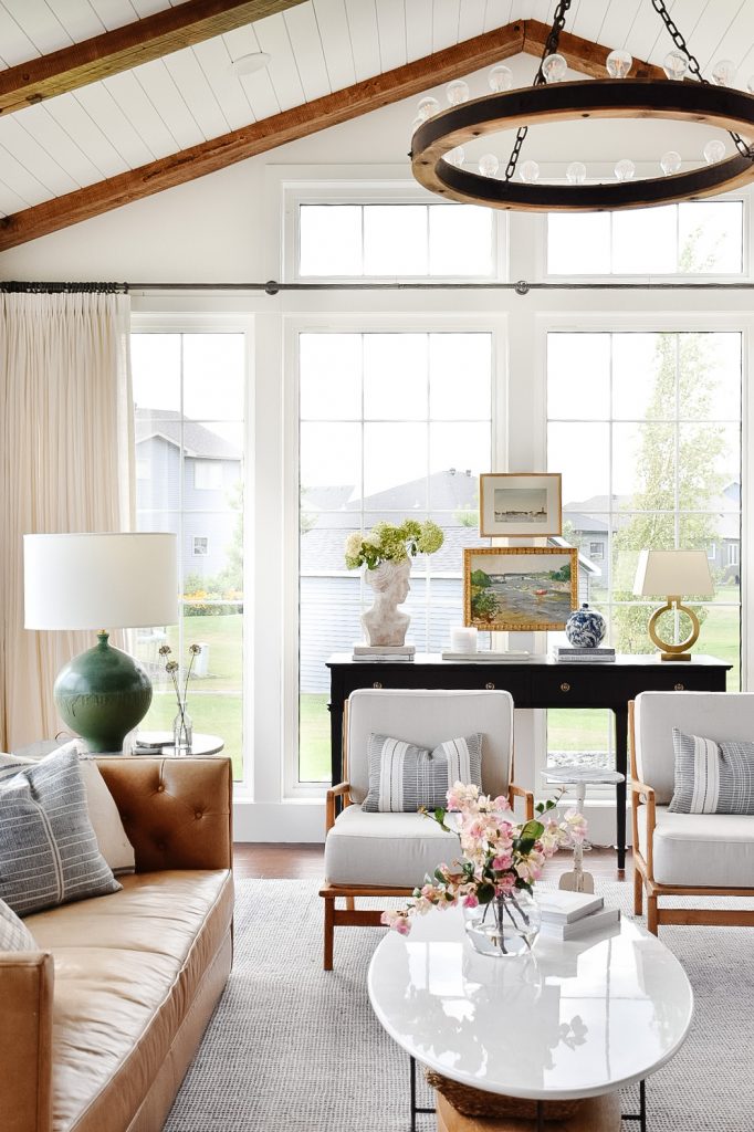 Mixed metals in transitional sunroom family room.