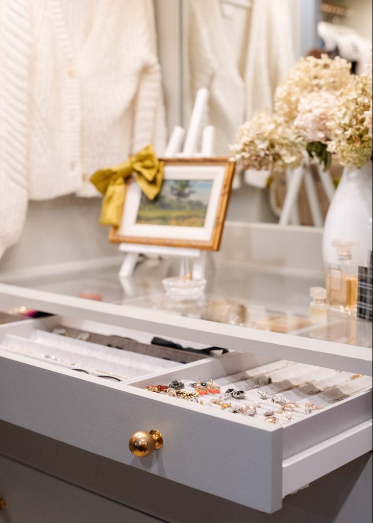 Brass knobs on a jewelry drawer in closet.